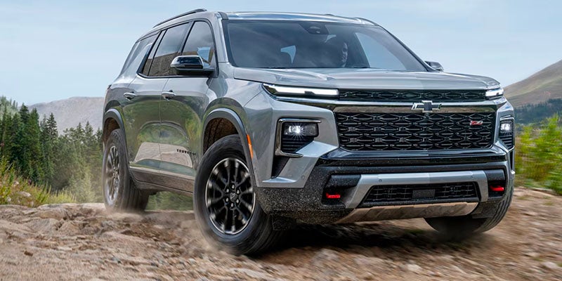 black chevrolet traverse car standing on hill